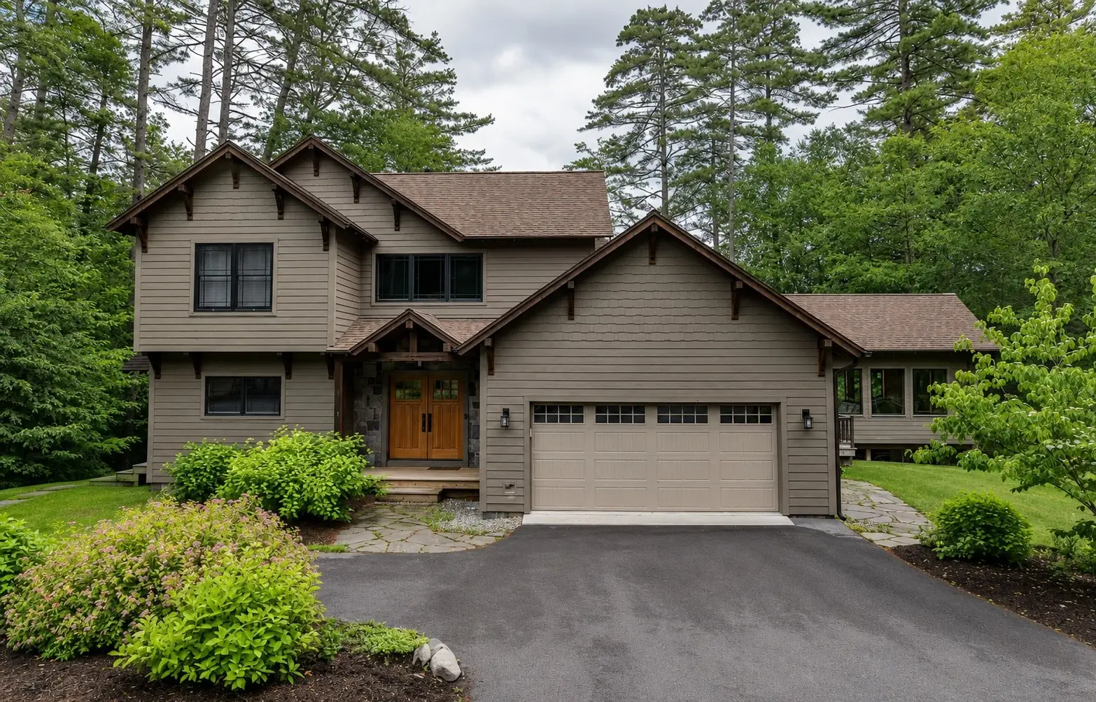 Craftsman-style home with a timber-trimmed entry and a two-car garage