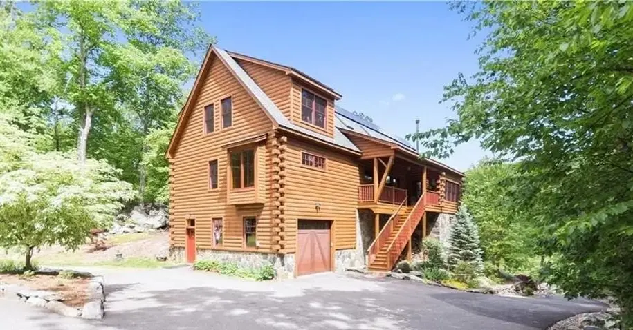 Log home with a garage below and an outside stair to the deck